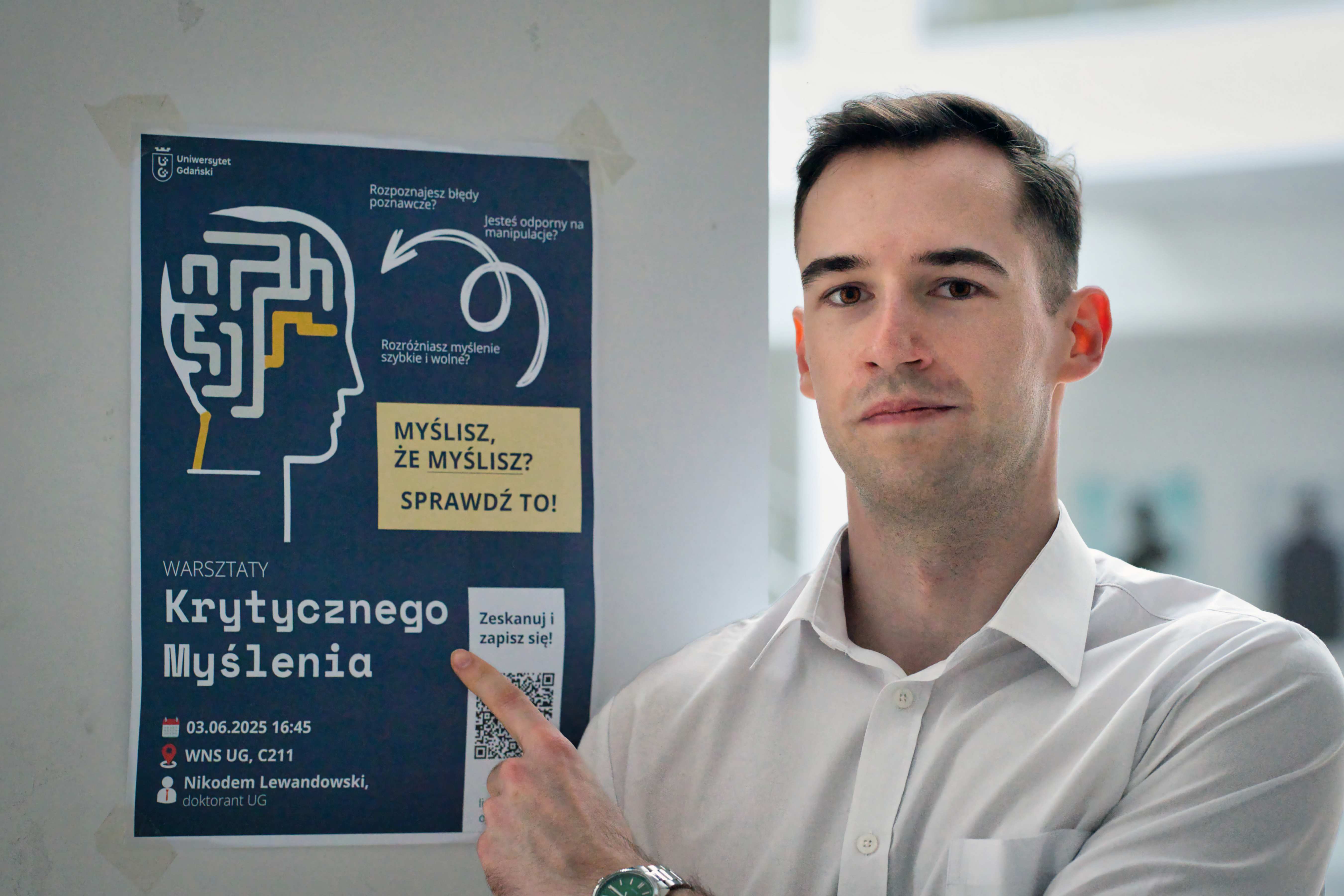 Nikodem Lewandowski next to his criticall thinking workshops poster